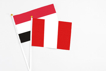 Peru and Egypt stick flags on white background. High quality fabric, miniature national flag. Peaceful global concept.White floor for copy space.