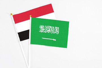 Saudi Arabia and Egypt stick flags on white background. High quality fabric, miniature national flag. Peaceful global concept.White floor for copy space.