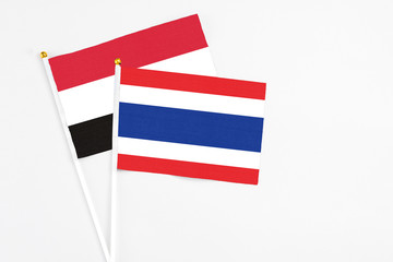 Thailand and Egypt stick flags on white background. High quality fabric, miniature national flag. Peaceful global concept.White floor for copy space.