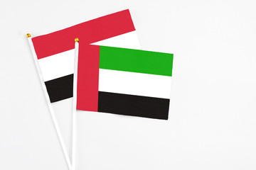 United Arab Emirates and Egypt stick flags on white background. High quality fabric, miniature national flag. Peaceful global concept.White floor for copy space.