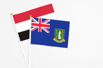 Fototapeta premium British Virgin Islands and Egypt stick flags on white background. High quality fabric, miniature national flag. Peaceful global concept.White floor for copy space.