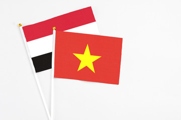 Vietnam and Egypt stick flags on white background. High quality fabric, miniature national flag. Peaceful global concept.White floor for copy space.