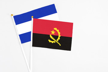 Angola and El Salvador stick flags on white background. High quality fabric, miniature national flag. Peaceful global concept.White floor for copy space.