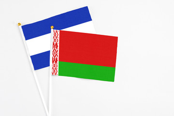 Belarus and El Salvador stick flags on white background. High quality fabric, miniature national flag. Peaceful global concept.White floor for copy space.