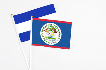 Belize and El Salvador stick flags on white background. High quality fabric, miniature national flag. Peaceful global concept.White floor for copy space.