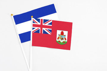 Bermuda and El Salvador stick flags on white background. High quality fabric, miniature national flag. Peaceful global concept.White floor for copy space.