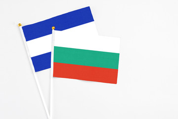 Bulgaria and El Salvador stick flags on white background. High quality fabric, miniature national flag. Peaceful global concept.White floor for copy space.