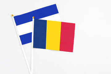 Chad and El Salvador stick flags on white background. High quality fabric, miniature national flag. Peaceful global concept.White floor for copy space.