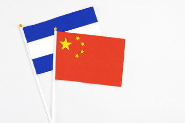 China and El Salvador stick flags on white background. High quality fabric, miniature national flag. Peaceful global concept.White floor for copy space.