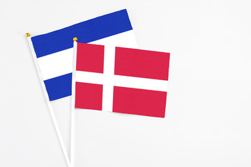 Denmark and El Salvador stick flags on white background. High quality fabric, miniature national flag. Peaceful global concept.White floor for copy space.