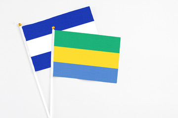 Gabon and El Salvador stick flags on white background. High quality fabric, miniature national...