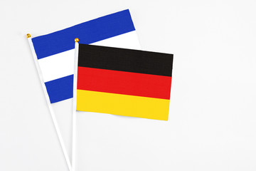 Germany and El Salvador stick flags on white background. High quality fabric, miniature national flag. Peaceful global concept.White floor for copy space.