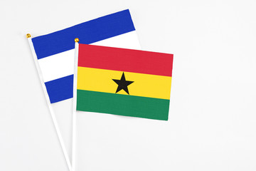 Ghana and El Salvador stick flags on white background. High quality fabric, miniature national flag. Peaceful global concept.White floor for copy space.