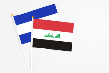 Iraq and El Salvador stick flags on white background. High quality fabric, miniature national flag. Peaceful global concept.White floor for copy space.