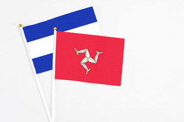Isle Of Man and El Salvador stick flags on white background. High quality fabric, miniature national flag. Peaceful global concept.White floor for copy space.