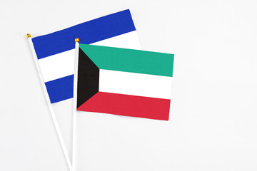 Kuwait and El Salvador stick flags on white background. High quality fabric, miniature national flag. Peaceful global concept.White floor for copy space.