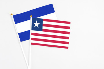 Liberia and El Salvador stick flags on white background. High quality fabric, miniature national flag. Peaceful global concept.White floor for copy space.