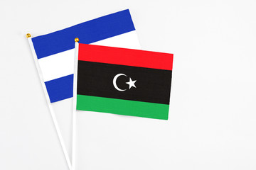 Libya and El Salvador stick flags on white background. High quality fabric, miniature national flag. Peaceful global concept.White floor for copy space.