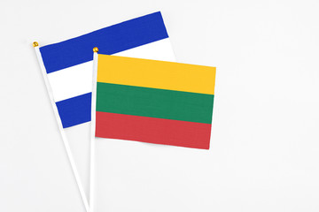 Lithuania and El Salvador stick flags on white background. High quality fabric, miniature national flag. Peaceful global concept.White floor for copy space.