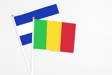 Mali and El Salvador stick flags on white background. High quality fabric, miniature national flag. Peaceful global concept.White floor for copy space.