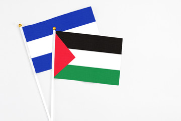Palestine and El Salvador stick flags on white background. High quality fabric, miniature national flag. Peaceful global concept.White floor for copy space.