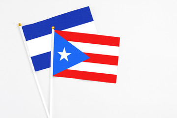 Puerto Rico and El Salvador stick flags on white background. High quality fabric, miniature national flag. Peaceful global concept.White floor for copy space.