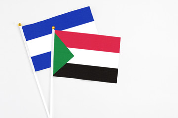 Sudan and El Salvador stick flags on white background. High quality fabric, miniature national flag. Peaceful global concept.White floor for copy space.