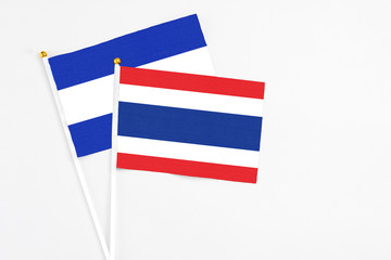 Thailand and El Salvador stick flags on white background. High quality fabric, miniature national flag. Peaceful global concept.White floor for copy space.