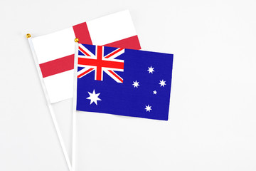 Fototapeta premium Australia and England stick flags on white background. High quality fabric, miniature national flag. Peaceful global concept.White floor for copy space.