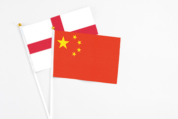 China and England stick flags on white background. High quality fabric, miniature national flag. Peaceful global concept.White floor for copy space.