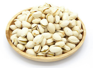 pistachio nuts healthy in wood bowl on white background