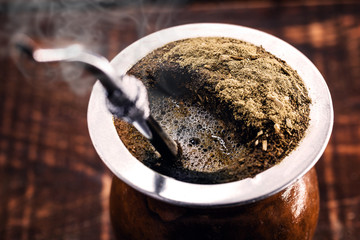 A typical Brazilian drink, o chimarrão, or mate, is a character - obrazy, fototapety, plakaty