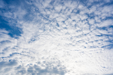 White clouds over blue sky background