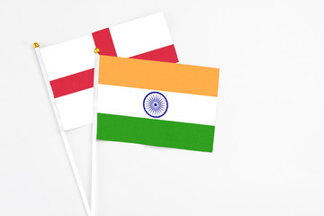 India and England stick flags on white background. High quality fabric, miniature national flag. Peaceful global concept.White floor for copy space.