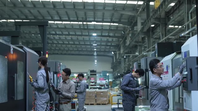 Chinese engineers operating in factory,HD