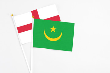 Mauritania and England stick flags on white background. High quality fabric, miniature national flag. Peaceful global concept.White floor for copy space.