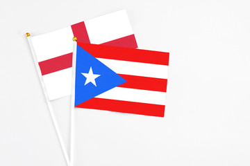 Puerto Rico and England stick flags on white background. High quality fabric, miniature national flag. Peaceful global concept.White floor for copy space.