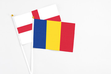 Romania and England stick flags on white background. High quality fabric, miniature national flag. Peaceful global concept.White floor for copy space.