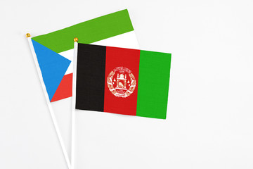 Afghanistan and Equatorial Guinea stick flags on white background. High quality fabric, miniature national flag. Peaceful global concept.White floor for copy space.