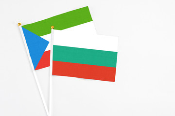 Bulgaria and Equatorial Guinea stick flags on white background. High quality fabric, miniature national flag. Peaceful global concept.White floor for copy space.