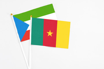 Naklejka premium Cameroon and Equatorial Guinea stick flags on white background. High quality fabric, miniature national flag. Peaceful global concept.White floor for copy space.