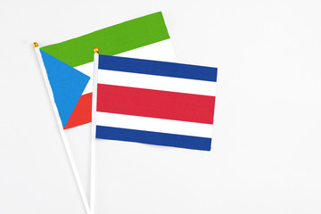Costa Rica and Equatorial Guinea stick flags on white background. High quality fabric, miniature national flag. Peaceful global concept.White floor for copy space.