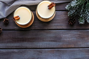 Eggnog - cute New Year composition with alcoholic drink on dark wooden background top view frame copy space