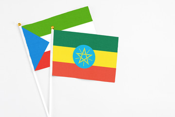 Ethiopia and Equatorial Guinea stick flags on white background. High quality fabric, miniature national flag. Peaceful global concept.White floor for copy space.