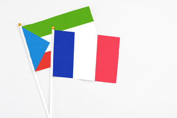France and Equatorial Guinea stick flags on white background. High quality fabric, miniature national flag. Peaceful global concept.White floor for copy space.