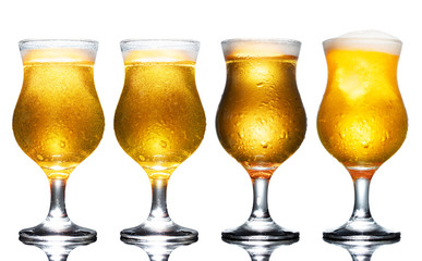 Set of a glass of cold light beer with foam isolated on white background