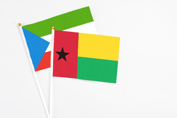 Guinea Bissau and Equatorial Guinea stick flags on white background. High quality fabric, miniature national flag. Peaceful global concept.White floor for copy space.