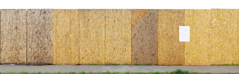 Construction site long yellow fence is made of wooden resin-impregnated chipboards isolated