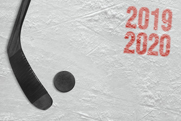 Hockey stick and puck on the ice arena