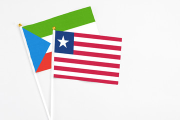 Liberia and Equatorial Guinea stick flags on white background. High quality fabric, miniature national flag. Peaceful global concept.White floor for copy space.